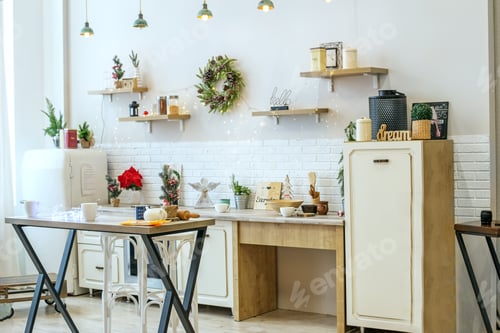Preview: Bright kitchen interior with Christmas decor and Christmas wreath. Kitchenware.