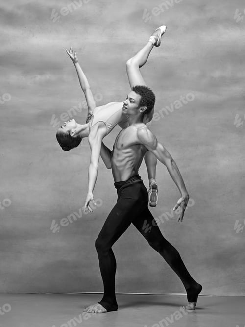 Preview: Couple of ballet dancers posing over gray background
