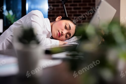 Preview: Exhausted financial accountant suffering from sleepiness after overtime working hours.