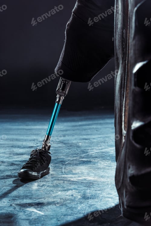 Preview: selective focus of leg prosthesis of paralympic sportsman near tire