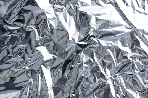 Preview: Crumpled silver foil as background, closeup view