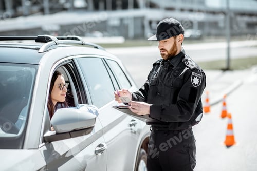 Preview: Policeman with woman driver on the road