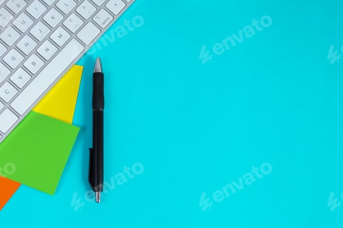 Preview: Keyboard, Pen And Colorful Sticky Notes Arranged On Blue Background