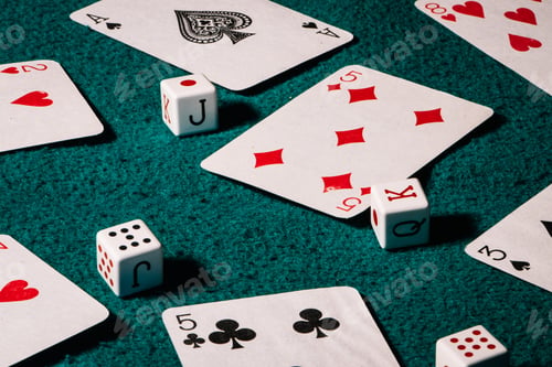 Preview: Selective focus shot of poker dices and cards on a green mat