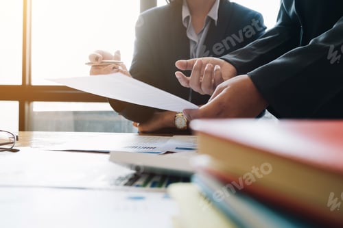 Preview: Business and partnership discussing using calculator to review balance sheet annual with holding pen
