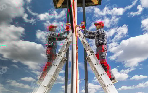 Preview: Worker Climbing Ladder for Maintenance on a Clear Day
