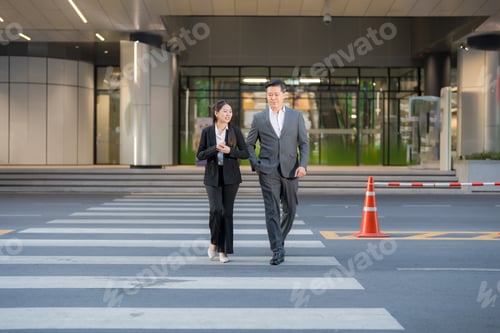 Preview: Business colleagues walking across street