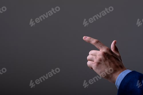 Preview: Midsection of caucasian businessman touching virtual interface, isolated on grey background