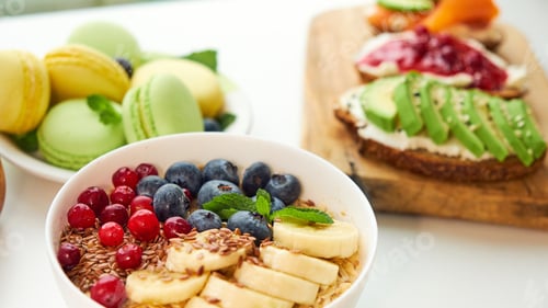 Vista previa: breakfast top view white background. oatmeal with berries, toasts on a wooden tray, nuts, coffee