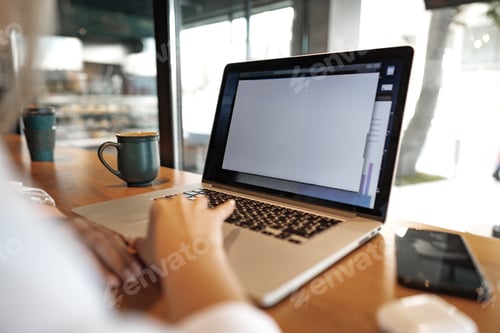 Preview: Close up of woman hands typing on laptop in cafe