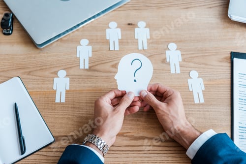 Preview: cropped view of recruiter holding paper human shape with question mark on table