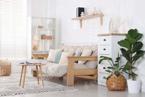 Preview: Beautiful sofa with cushions and coffee table in living room. Interior design
