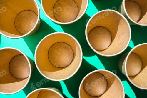 Preview: Empty recyclable paper cups on green background. Many takeaway cups for drink. Eco friendly. Zero wa