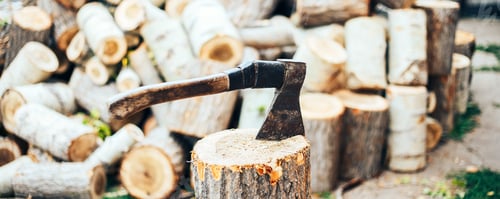Preview: A sharp blade of an ax that sticks out in a wooden chock. rustic concept