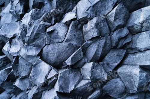 Preview: Basalt stones as a background. Reynisfjara Beach, Iceland. Sharp rocks.