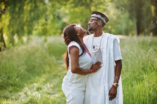 Preview: Black african couple in love kissing at green park on sunset