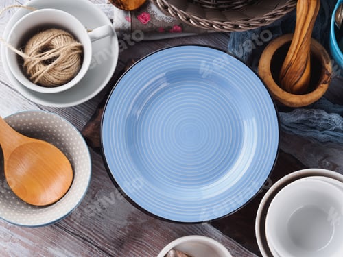 Preview: Ceramic and enamel crockery on wooden background