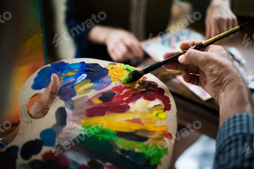 Preview: Artist painting artwork at workspace