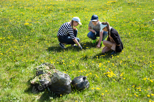 Preview: Close-up view of teenagers with gloves and garbage bags walking. Ecology protection concept.