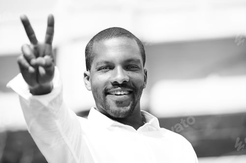Preview: Portrait of Young smiling african-american man wearing informal clothes outside.