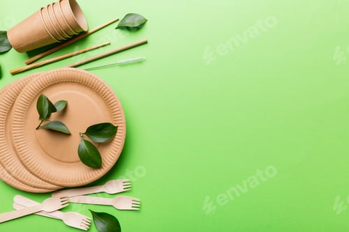Preview: set of empty reusable disposable eco-friendly plates, cups, utensils on light white table background