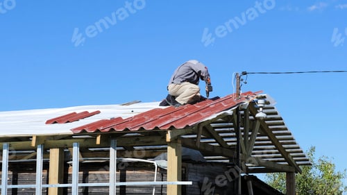Preview: Man screws a screw into the roof. Stock footage. The professional worker works on installation of a