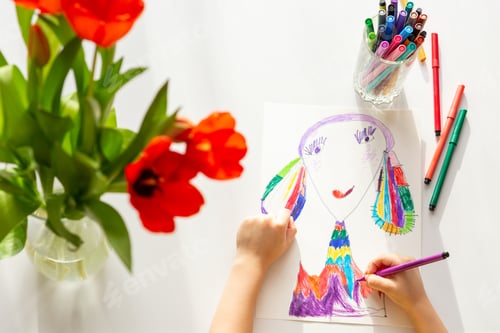 Preview: Top view . Close-up of children's hands draw a portrait of mom