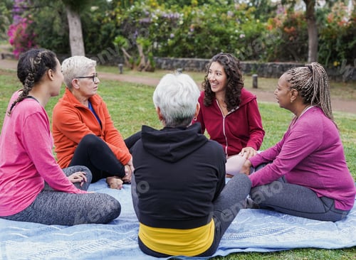 Preview: Multiracial women sitting and talking at city park - Multi generational people having fun together
