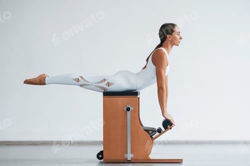 Preview: Exercise for the spine. Confident young sporty woman with slim body type in the healthy center