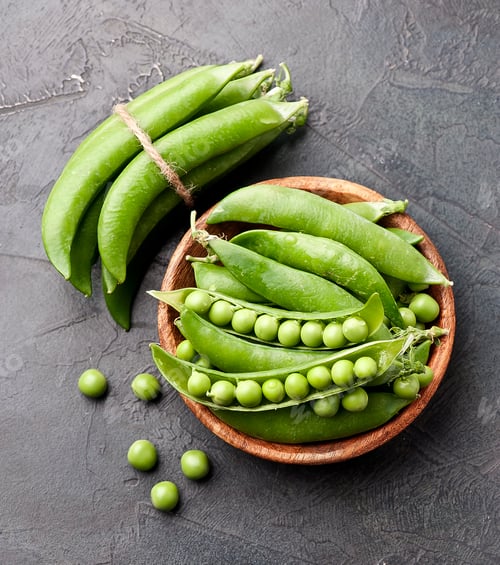 Preview: Young green peas in wooden plate