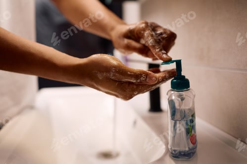 Preview: Close up of black man washing hands in the bathroom.