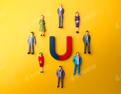 Preview: Businessman attracts by magnet on a yellow background. Business and leadership concept.