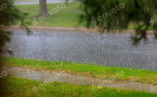 Preview: Road during heavy rain. raindrops on water puddles bad weather