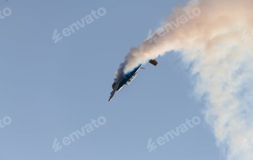 Preview: Aerobatic propeller airplane performing a steep maneuver while releasing smoke