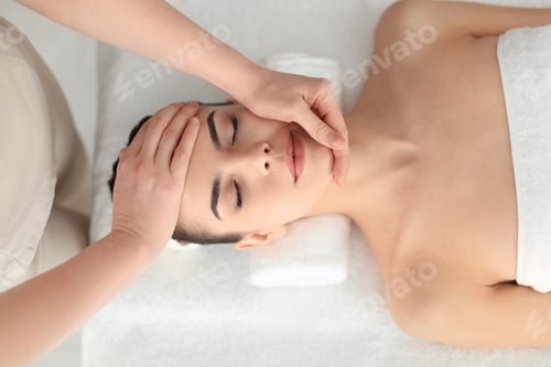 Preview: Young woman receiving massage in spa salon