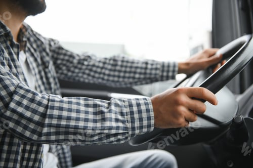 Preview: Man driving a truck holding steering wheel
