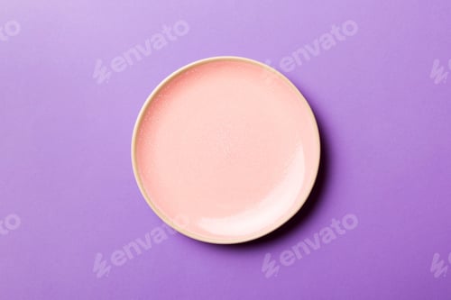 Preview: Top view of isolated of colored background empty round pink plate for food.