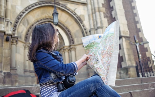 Preview: Young woman with map in old city center