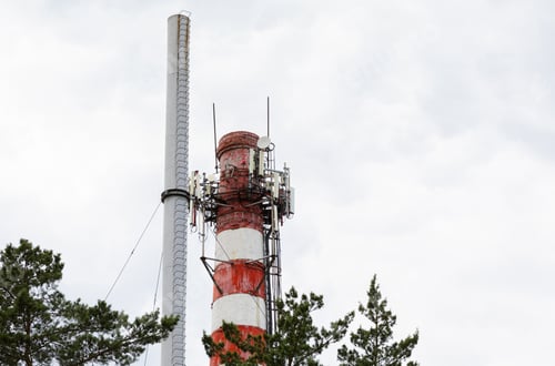 Preview: Red white chimney on blue sky with furry clouds background