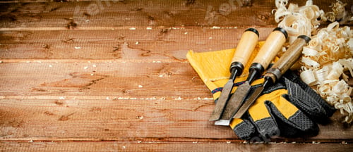 Preview: Chisels with wooden sawdust on the table.