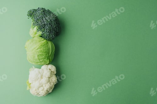 Preview: Healthy fresh broccoli, cabbage and cauliflower on green background