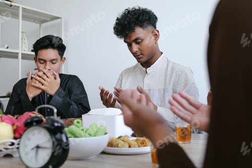 Preview: Diverse Muslim Friends Praying Before Breaking The Fast of Iftar on Ramadan Kareem