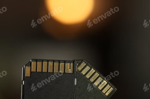 Preview: Two SD memory cards on blurred background, closeup. Space for text