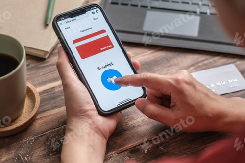 Preview: close up woman hand choosing e-wallet instead of credit card shopping online on mobile app at home