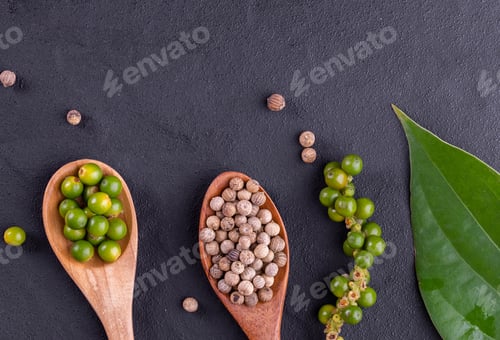 Preview: Black pepper spice peppercorn on wooden spoon and dark rustic background