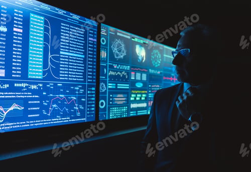 Preview: The man standing near the blue screen with charts in the dark room