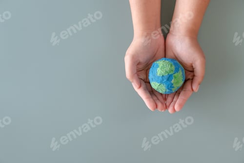 Preview: Hands holding earth paper and water paint. Concept of sustainability environment protection