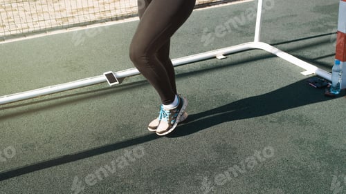Preview: Outdoor workout, active lifestyle. Close-up of a fitness woman's legs in sneakers running in