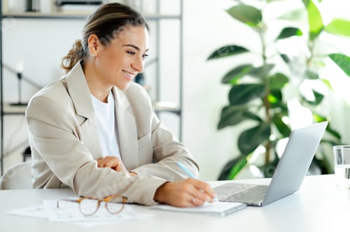 Preview: Smiling Woman Working at Computer in Office