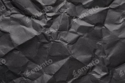Preview: Sheet of black crumpled paper as background. Space for design
